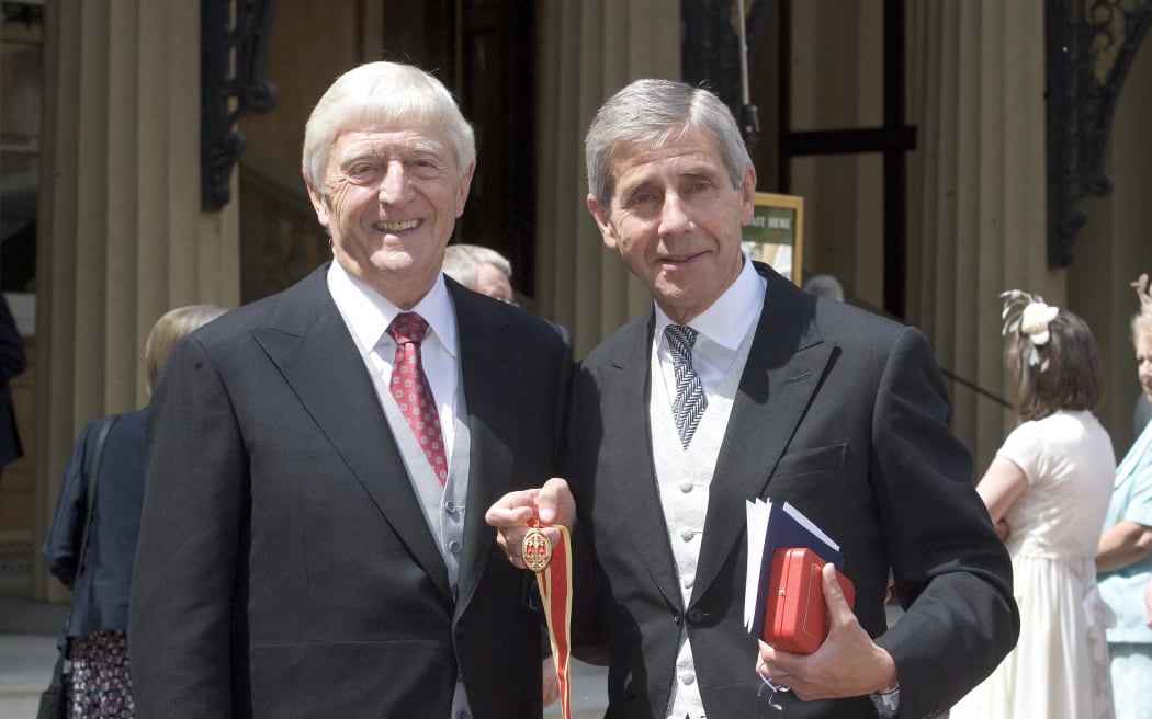 Television presenter Sir Michael Parkinson (L) and Chief Executive of Marks & Spencer Sir Stuart Rose pose for photographs after receiving their Honour of Knighthood from Britain's Queen Elizabeth II at Buckingham Palace, in London, on June 4, 2008. AFP PHOTO/Jenny Goodall/POOL (Photo by JENNY GOODALL / POOL / AFP)