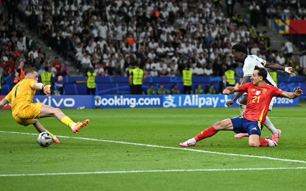 Spain's midfielder No. 21 Mikel Oyarzabal kicks the ball and scores his team's second goal against England's goalkeeper No. 1 Jordan Pickford during the UEFA Euro 2024 final football match between Spain and England at the Olympiastadion in Berlin on July 14, 2024.