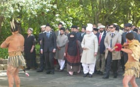His Holiness Mirza Masroor Ahmad, wearing white, was welcomed onto the marae.
