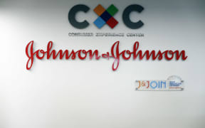 Logo of US multinational medical devices and pharmaceutical company Johnson & Johnson at the entrance of the research and development plant, in Val-de-Reuil, northwestern France.