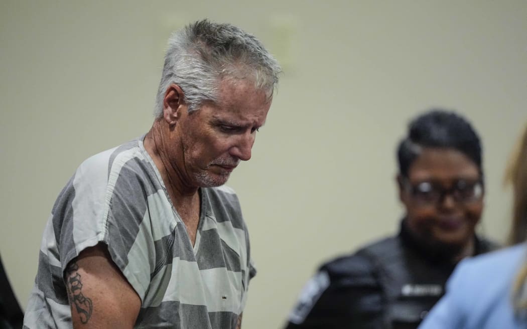 WINDER, GEORGIA - SEPTEMBER 6: Colin Gray, 54, the father of Apalachee High School shooting suspect Colt Gray, 14, enters the Barrow County courthouse for his first appearance, on September 6, 2024, in Winder, Georgia. Colin Gray is being charged with involuntary manslaughter, second-degree murder and cruelty to children after his son opened fire and killed 4 at the high school on Wednesday.   Brynn Anderson-Pool/Getty Images/AFP (Photo by POOL / GETTY IMAGES NORTH AMERICA / Getty Images via AFP)