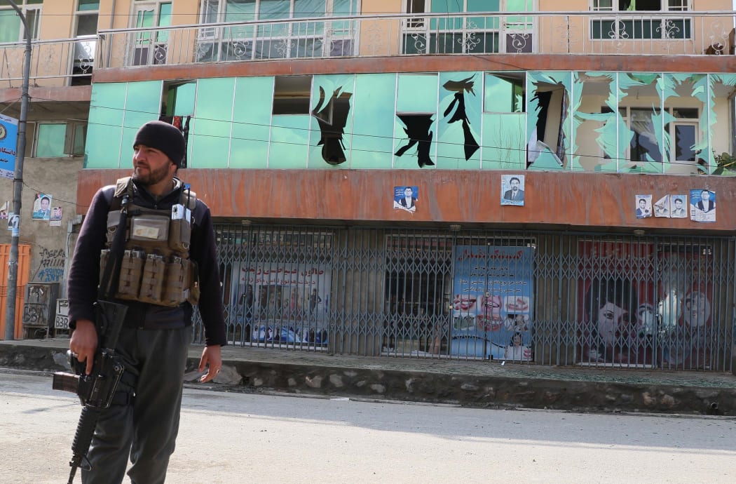 Afghan security forces stand guard at the blast site after three consecutive explosions targeted a gathering celebrating Nowruz festival in Kabul.