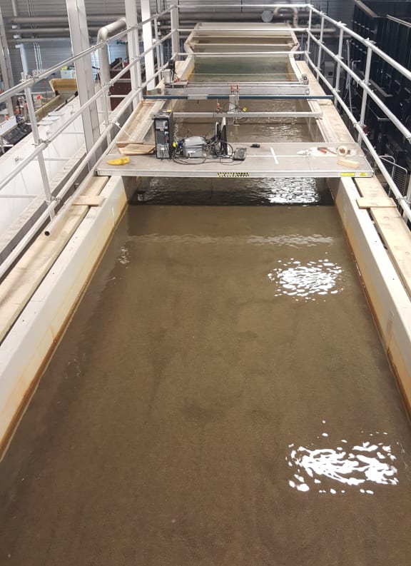 Engineers model what happens in streams and rivers using a flume, which is a long tank along which water flows.