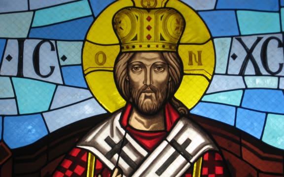 Christ depicted as a king with a crown. Stained glass window.