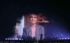 A screen shows Canadian singer Celine Dion giving a recorded message during the first semi-final of the Eurovision Song Contest 2025, at the St. Jakobshalle arena in Basel on May 13, 2025. (Photo by SEBASTIEN BOZON / AFP)