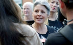 Laila Harre speaks to media before voting in the Epsom electorate on Suffrage Day.