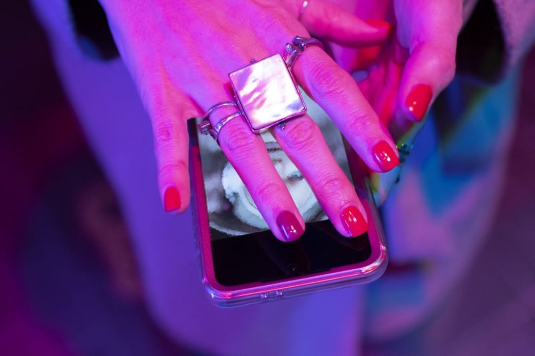 Close-up of hand of woman with red manicure covering smart phone. (Photo by Tom Merton/CAIA IMAGE/SCIENCE PH / NEW / Science Photo Library via AFP)