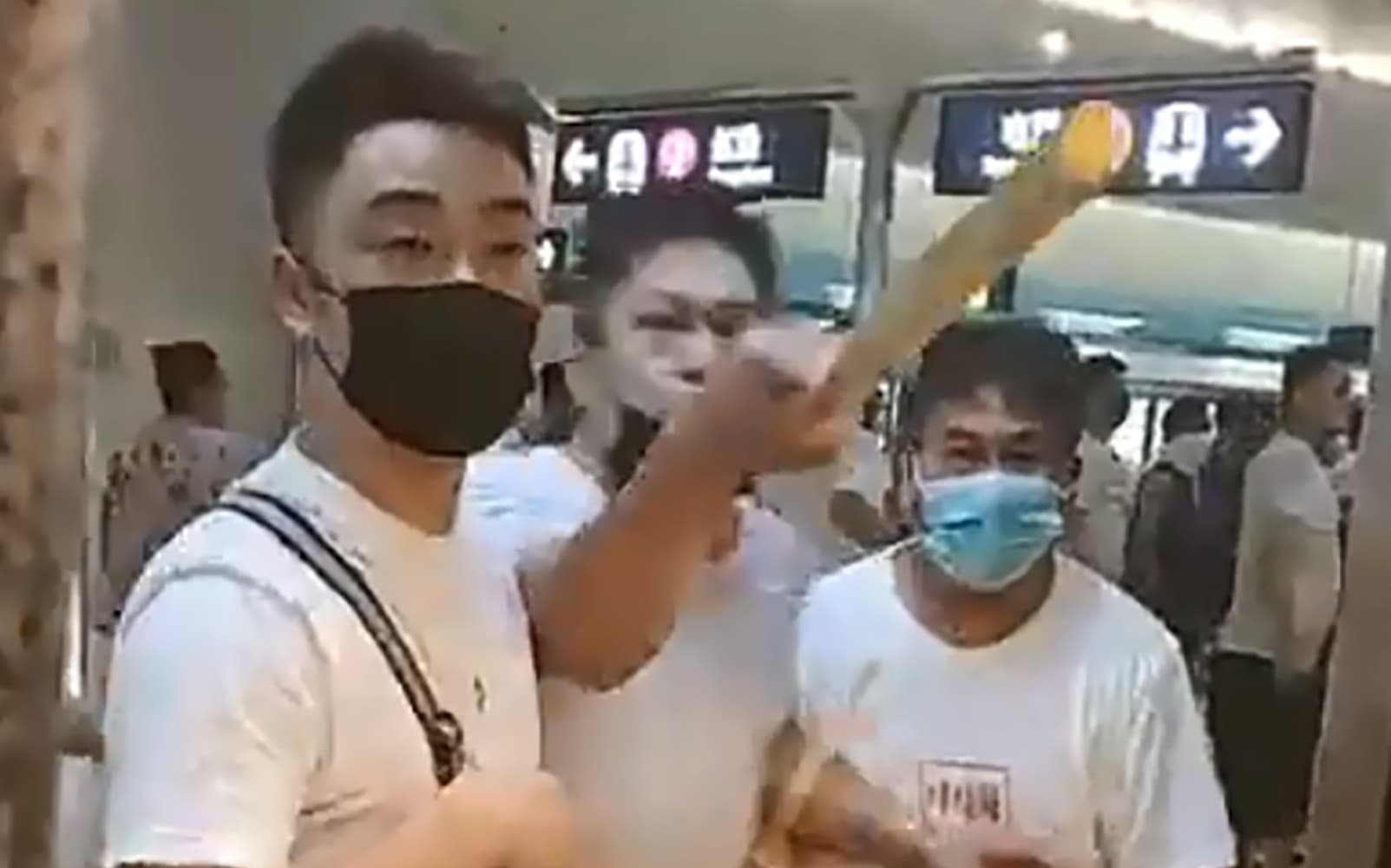 This frame grab taken from video recorded on July 21, 2019 shows a mob of men in white T-shirts threatening pro-democracy protesters (out of frame at R on train) at Yuen Long station in Hong Kong.