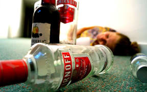 woman passed out with alcohol bottles