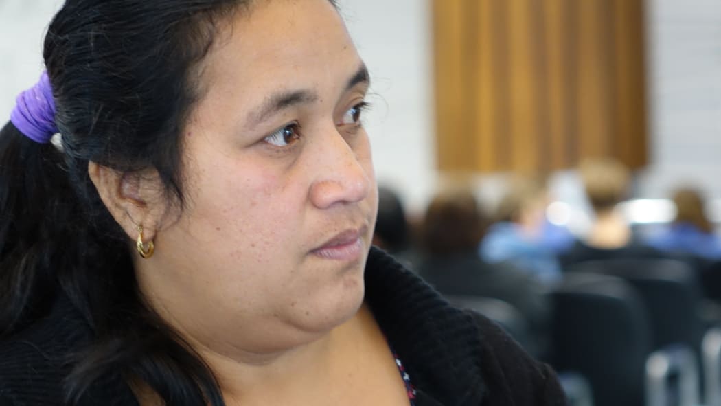 Ioane Teitiota's wife, Angua Erika, waits as her husband prepares to leave Auckland International Airport on Wednesday 23 September 2015. The family's application to be considered refugees from the effects of climate change in Kiribati has been declined, and Mr Teitiota is being deported today.