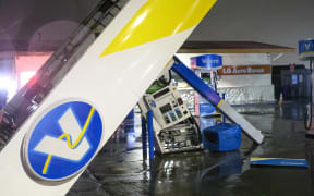 A damaged Valero gas station creaks in the wind during a massive "bomb cyclone" rain storm in South San Francisco, California on January 5.