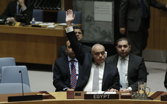 Amr Abdel Latif Aboulatta, Permanent Representative of Egypt to the UN, votes in favor of the ban on Israeli settlements.