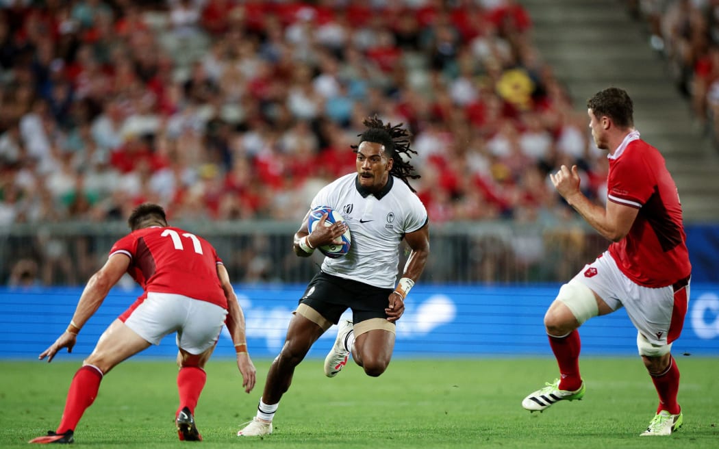 BORDEAUX, FRANCE - SEPTEMBER 10: Selesitino Ravutaumada of Fiji breaks forward on the ball ahead of Josh Adams of Wales during the Rugby World Cup France 2023 match between Wales and Fiji at Nouveau Stade de Bordeaux on September 10, 2023 in Bordeaux, France. (Photo by Adam Pretty - World Rugby/World Rugby via Getty Images)