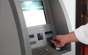 Close up of hand of a man using banking machine