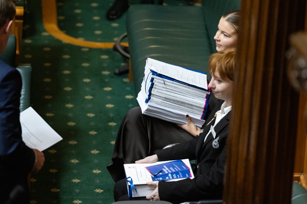 Chamber and House staffers wait with copies of budget documents to Table once they are introduced.