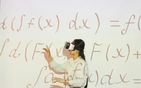 woman with VR headset and projected mathematical equations
