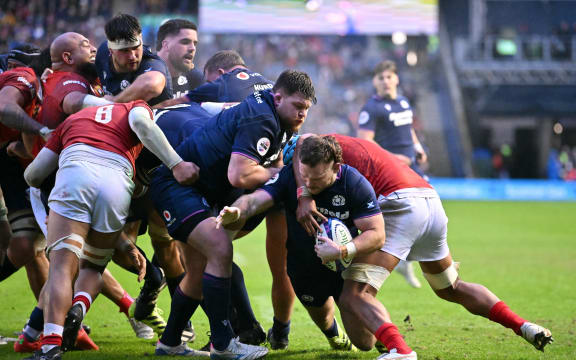 Scotland's hooker Ewan Ashman dives to the line to score his second try during the Autumn Nations Series international rugby union match between Scotland and Tonga at Murrayfield in Edinburgh on November 23, 2025. (Photo by ANDY BUCHANAN / AFP)