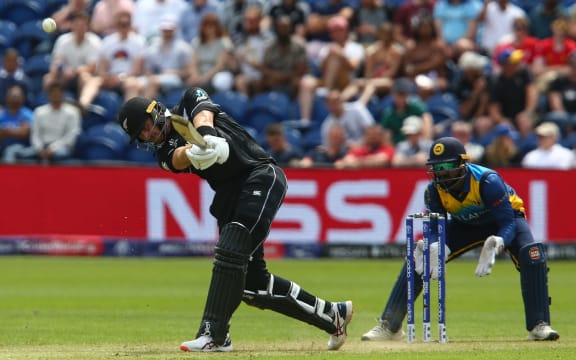 New Zealand's Martin Guptill (L) is watched by Sri Lanka's wicketkeeper Kusal Perera as he hits a six during the 2019 Cricket World Cup group stage match between New Zealand and Sri Lanka at Sophia Gardens stadium in Cardiff.