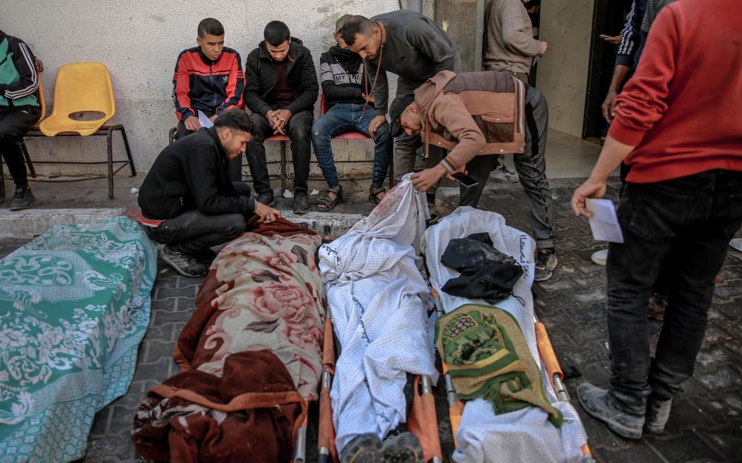 Palestinians identify relatives killed in Israeli bombardment in front of the morgue of the Al-Shifa hospital in Gaza City on March 15, 2024, amid the ongoing conflict between Israel and the Palestinian Hamas movement.