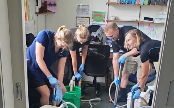 Paeroa Vet staff pump out floodwaters.