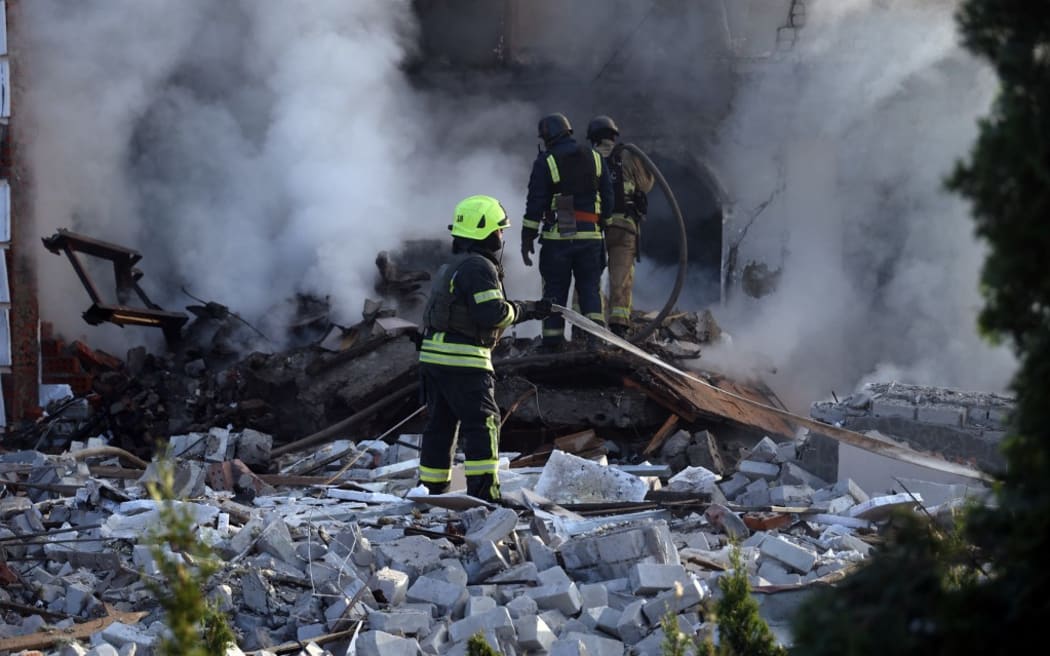 Rescuers are working at a house in Kharkiv, Ukraine, on May 10, 2024, after a Russian missile attack. During the night of May 10, Russian forces attacked Kharkiv with an S-300 missile. An 11-year-old child and a 72-year-old woman were injured in the attack on the residential area. Three houses caught fire, with two destroyed and one damaged. In total, 26 buildings were destroyed, and more than 300 windows were shattered. NO USE RUSSIA. NO USE BELARUS. (Photo by Ukrinform/NurPhoto) (Photo by Vyacheslav Madiyevskyy / NurPhoto / NurPhoto via AFP)