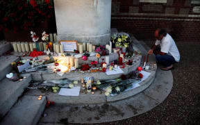 A make-shift memorial in front of the city hall in the Normandy city of Saint-Etienne-du-Rouvray after Father Jacques Hamel was killed in his church.