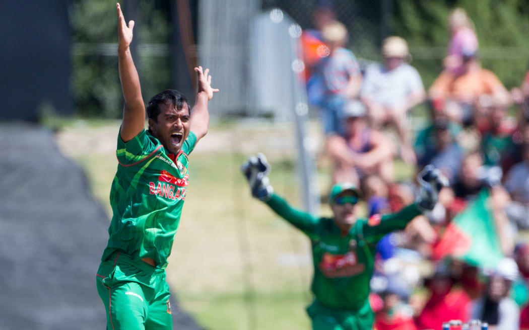 Rubel Hossain and Nurul Hasan Sohan celebrate the wicket of Jimmy Neesham.