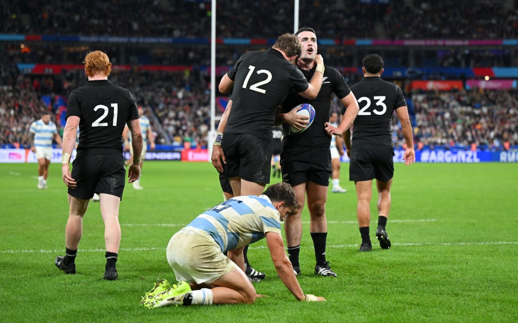 Will Jordan of New Zealand celebrates with teammate Jordie Barrett scoring his team's seventh try during the Rugby World Cup France 2023 semi-final match between Argentina and New Zealand at Stade de France