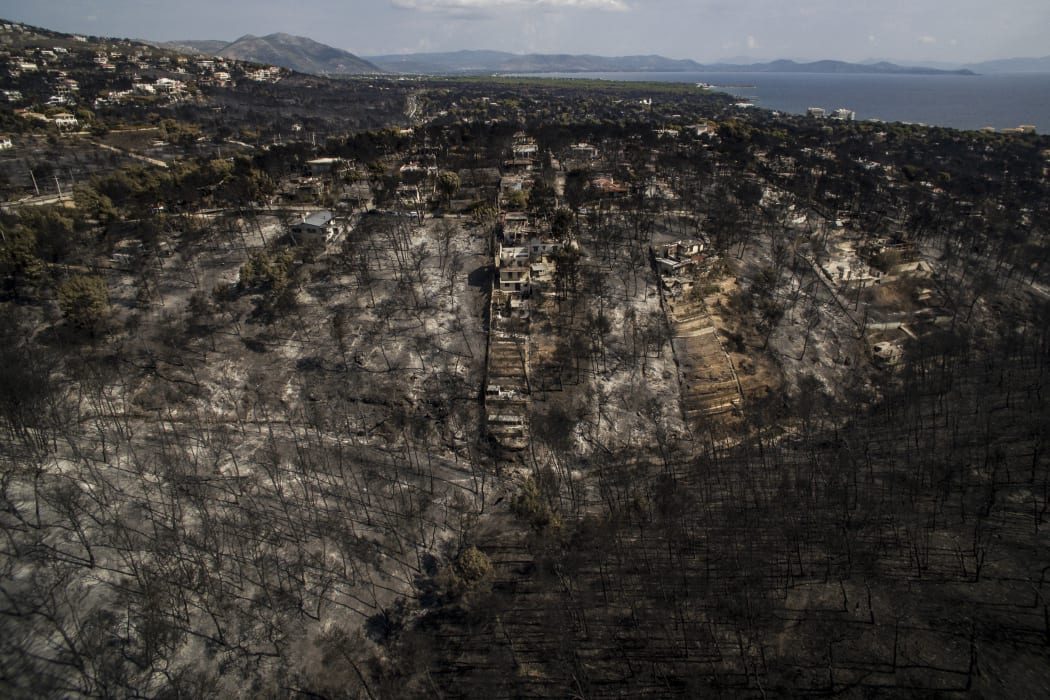 An aerial view shows a burnt area following a wildfire in the village of Mati, near Athens.