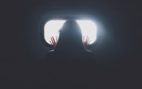 hand behind window