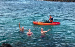 Caitlin O'Reilly celebrating her successful swim of the Moloka'i Channel with skipper Mike Twigg-Smith and Mike Cochrane.