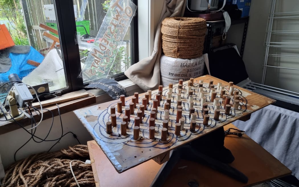 Steve Watt runs his business, Twisted Mats, from his work room at home.