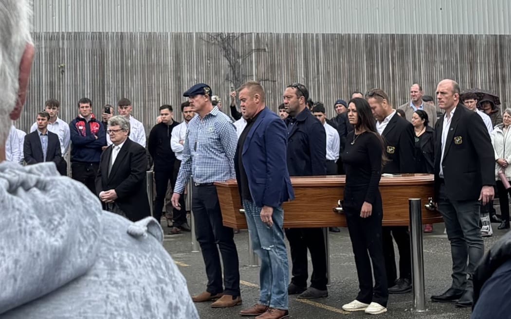 Shane Christie's coffin is carried into the funeral service.