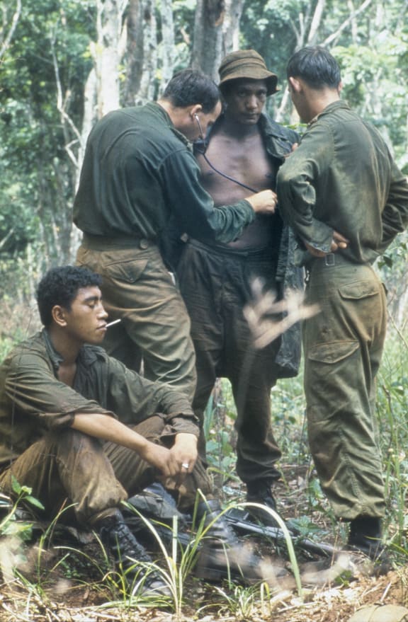 An Australian medical officer treating the New Zealand W Company during a resupply in the field during the Vietnam War.