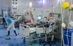 A doctor cleaning the floor of the intensive care unit at the Covid Center at the Thuwana football stadium in Yangon, Myanmar, on 1 January, 2021.