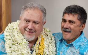 Moetai Brotherson (L) is congratulated by a member of his party after Brotherson was elected president of French Polynesia.