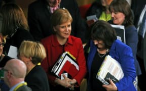 Scotland's First Minister Nicola Sturgeon (L) leaves after the vote on a second referendum on independence was carried at Scotland's Parliament in Holyrood, Edinburgh on March 28, 2017.