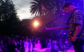 Drax Project bass player Sam Thomson on stage at the Wellington Botanic Garden's Soundshell.