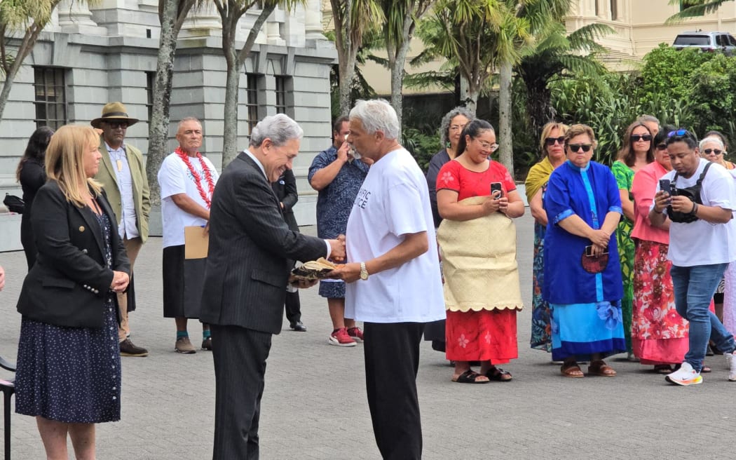 Winston Peters received a petition which calls for visas on arrival for Pacific Islanders outside Parliament on Wednesday