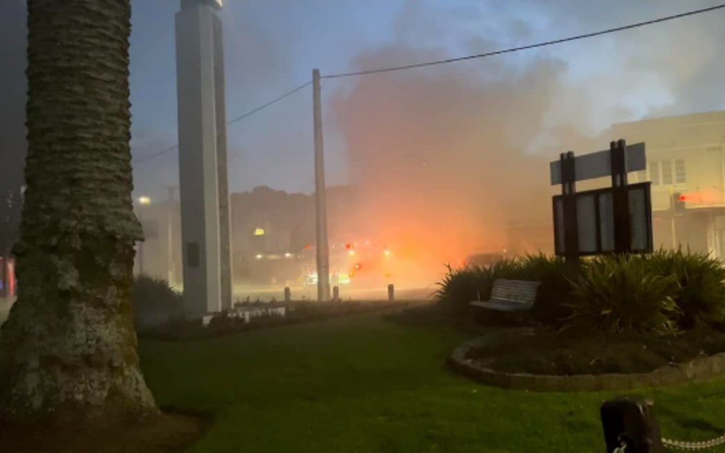 Smoke and a red glow was seen rising over Onehunga after a commercial building caught fire on 26 May, 2024.