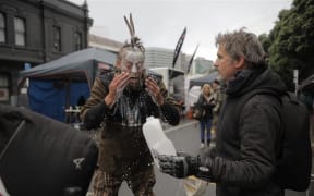 A protester washes their face with milk - something used to cool the effects of pepper spray.