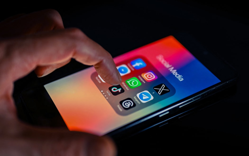 Close - up finger pointing to TokTok mobile app displayed on a smartphone screen alongside that of X,Whatsapp,Facebook,Messenger,Threads,Telegram, on August 15, 2023, in Brussels, Belgium. (Photo illustration by Jonathan Raa/NurPhoto) (Photo by Jonathan Raa / NurPhoto / NurPhoto via AFP)