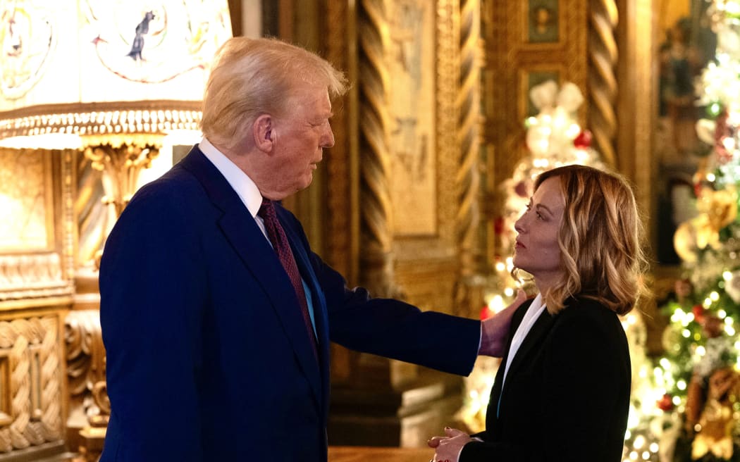 This handout picture released by the Palazzo Chigi press office on January 5, 2025 shows Italy's Prime Minister Giorgia Meloni talking with US President-elect Donald Trump at his Mar-A-Lago Club on January 4, 2025 in Palm Beach, Florida. (Photo by Filippo ATTILI / Palazzo Chigi press office / AFP) / RESTRICTED TO EDITORIAL USE - MANDATORY CREDIT "AFP PHOTO /PALAZZO CHIGI PRESS OFFICE/FILIPPO ATTILI" - NO MARKETING NO ADVERTISING CAMPAIGNS - DISTRIBUTED AS A SERVICE TO CLIENTS
