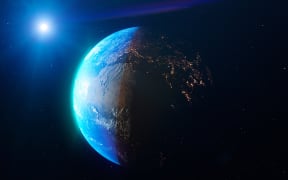 Satellite view of the Earth seen from space. The sun rising over the Europe and north Africa. Cities illuminated in the night. Sunrise