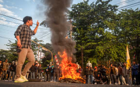 Students from the Indonesian Islamic Student Movement burn tires as they block a main provincial road during a protest against police violence in previous demonstrations, demanding that parliament review its policies, in Sleman, Yogyakarta, on 2 September, 2025.
