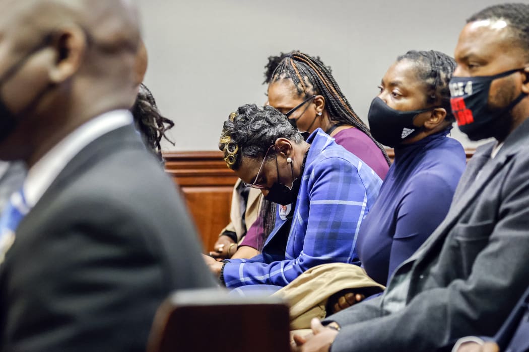 Ahmaud Arbery's mother Wanda Cooper-Jones reacts as Superior Court Judge Timothy Walmsley sentences Greg McMichael, his son, Travis McMichael, and a neighbor, William "Roddie" Bryan in the Glynn County Courthouse.