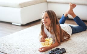 A child eating while watching TV