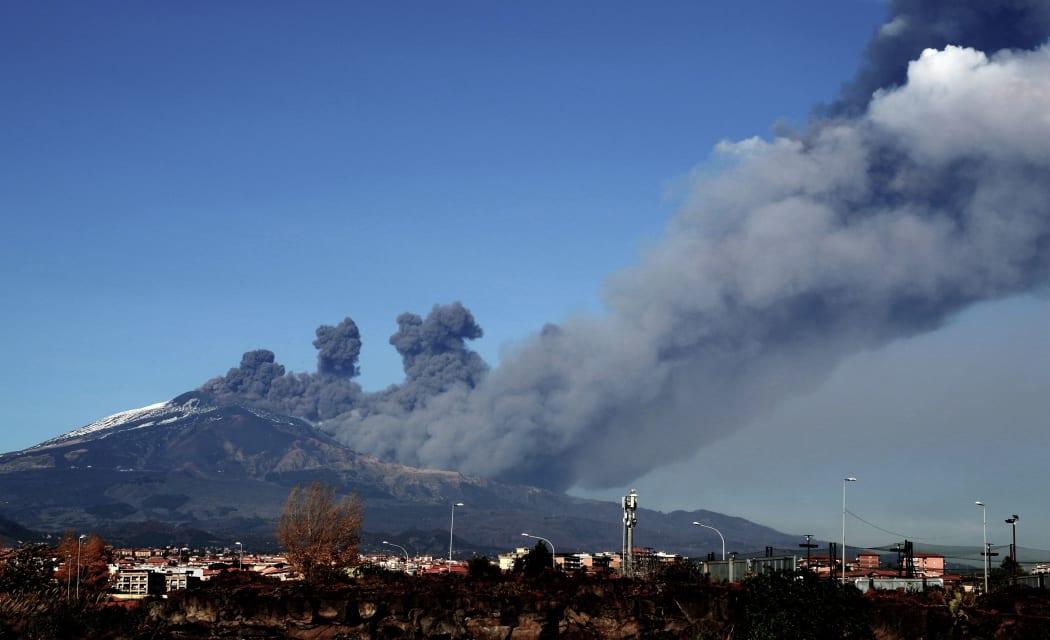 Smoke rises over the city of Catania during an eruption of the Mount Etna, one of the most active volcanoes in the world on December 24, 2018.