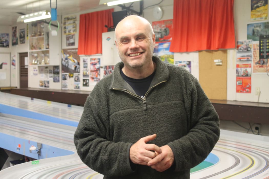 An image of Club president Stephen Murchison standing in front of the race track.