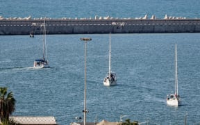Boats from the Global Sumud Flotilla intercepted by Israeli forces in the Mediterranean sea off the Gaza Strip waters, arrive in the southern port of Ashdod on October 2, 2025. Israel said on October 2 it will deport pro-Palestinian activists aboard the intercepted Sumud Flotilla of around 45 vessels, which began its voyage a month earlier, with politicians and activists aiming to break the siege and deliver aid to Gaza, where a famine was declared by the United Nations. (Photo by Saeed QAQ / AFP)